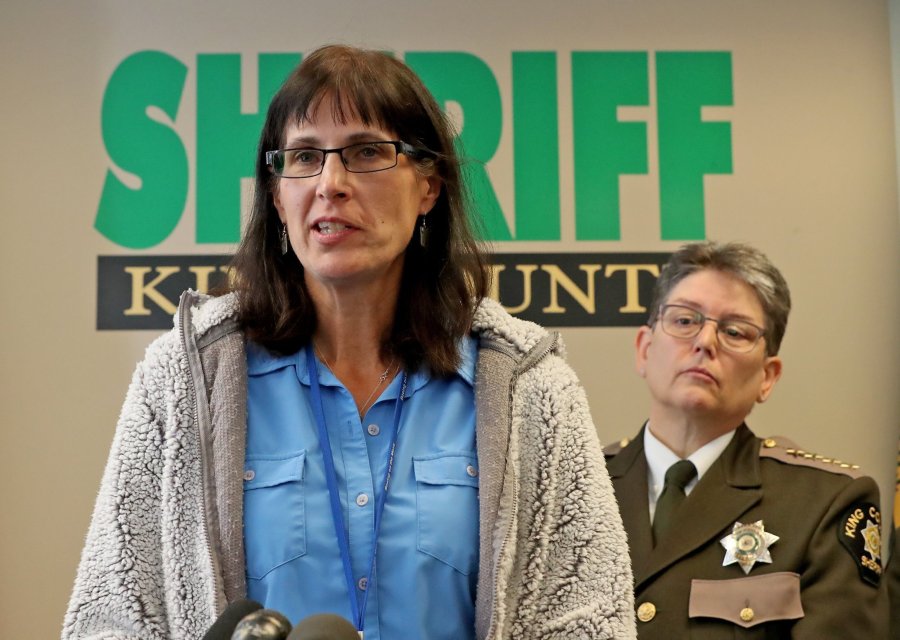 FILE - King County, Wash., Detective Kathleen Decker speaks at a news conference in 2019, while Sheriff Mitzi G. Johanknecht looks on, at right, in Seattle. On Tuesday, Dec. 12, 2023, King County agreed to pay $225,000 to settle a civil rights lawsuit brought by a Black man who was arrested on drug charges after the veteran detective Decker made false statements in obtaining a search warrant against him, including misidentifying him in a photo of an alleged gang member.