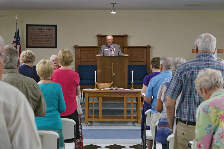FILE - The Rev. Bill Farmer, center, speaks to members of the congregation during service at the Grace Methodist Church Sunday, May 14, 2023, in Homosassa Springs, Fla. The new congregation was created by former United Methodists after their previous congregation voted to stay in that denomination. Grace Church affiliated with the more conservative Global Methodist Church. A quarter of U.S. congregations in the United Methodist Church have received permission to leave the denomination during a five-year window, closing in December 2023, that authorized departures for congregations over disputes involving the church&rsquo;s LGBTQ-related policies.