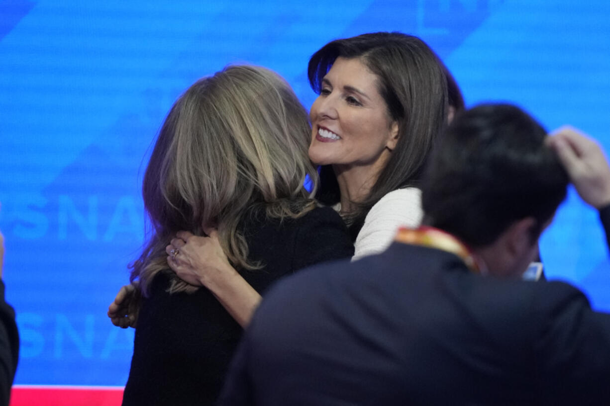 Republican presidential candidate former U.N. Ambassador Nikki Haley hugs her staff after a Republican presidential primary debate hosted by NewsNation on Wednesday, Dec. 6, 2023, at the Moody Music Hall at the University of Alabama in Tuscaloosa, Ala.