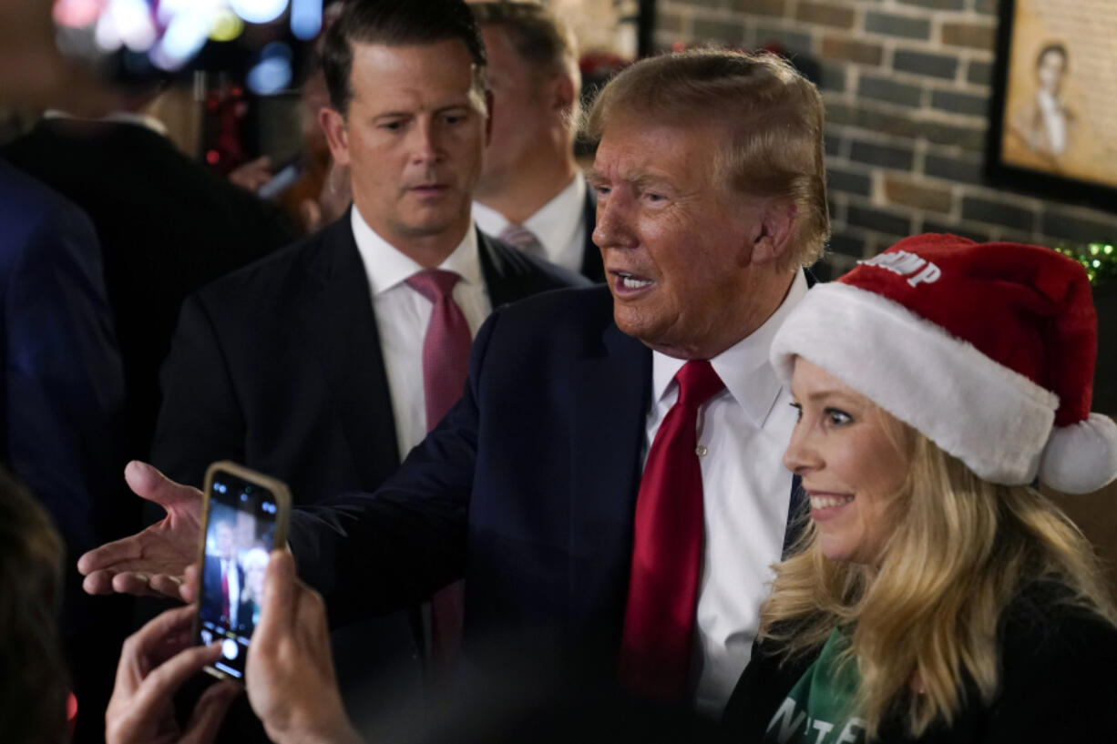 Former President Donald Trump greets supporters during a stop at the Front Street Pub &amp; Eatery, Tuesday, Dec. 5, 2023, in Davenport, Iowa.