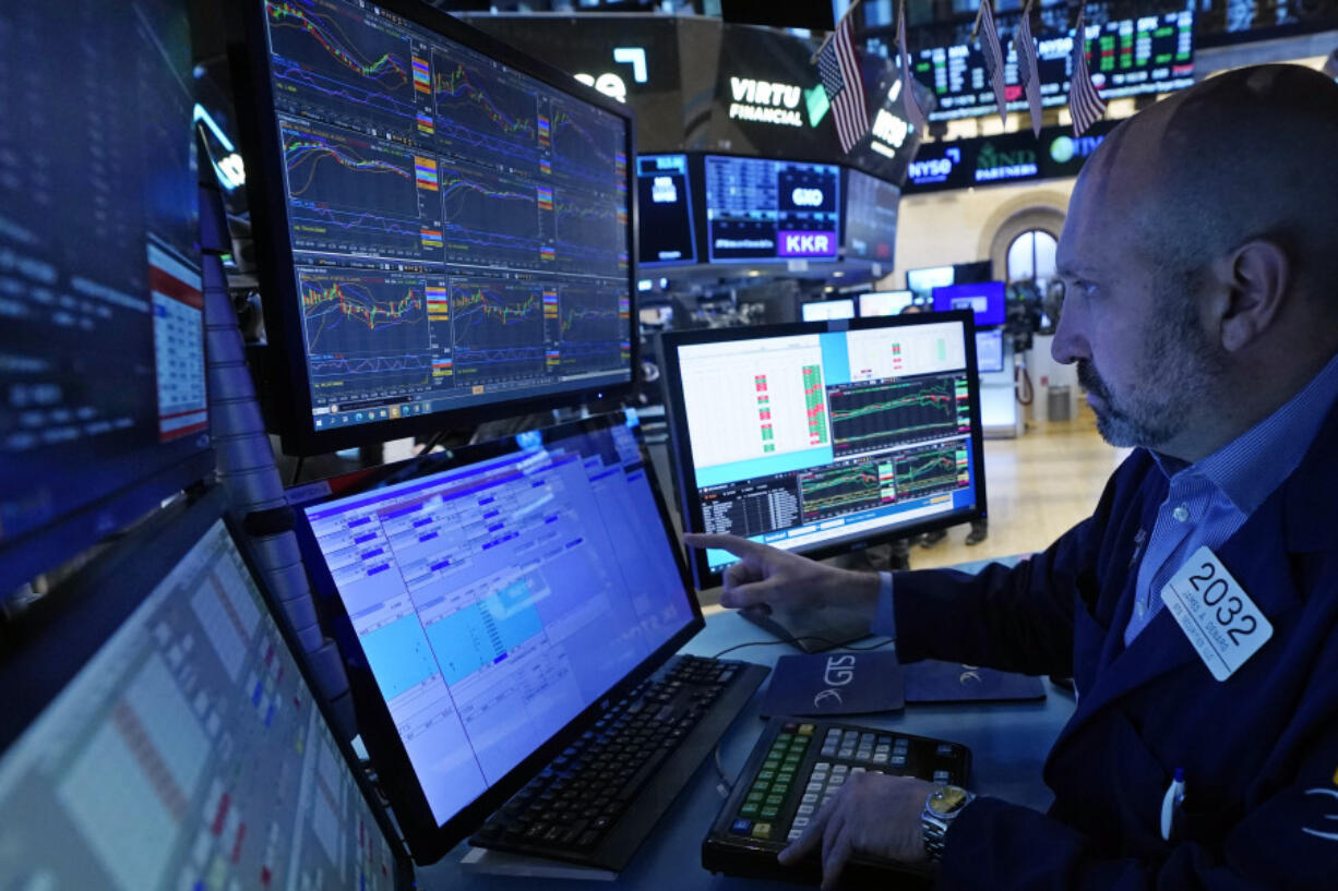 FILE - Specialist James Denaro works at his post on the floor of the New York Stock Exchange, Wednesday, Nov. 15, 2023. Stocks edged higher in morning trading on Wall Street Wednesday, Nov. 29, following some encouraging updates from U.S. companies, including General Motors.