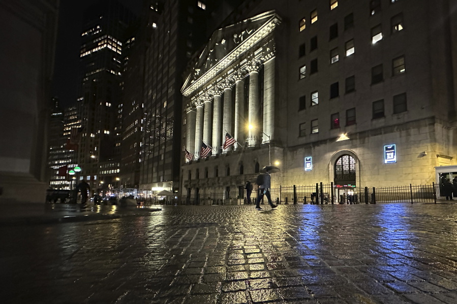 A man passes the New York Stock Exchange on Tuesday, Nov. 21, 2023 in New York.