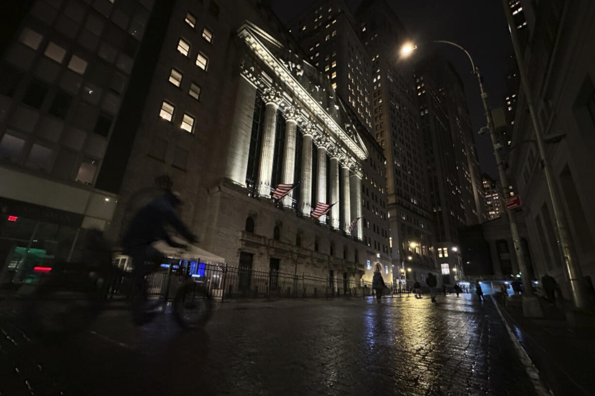 A bike approaches the New York Stock Exchange on Tuesday, Nov. 21, 2023 in New York. World shares were mixed on Wednesday in cautious trading after Wall Street&rsquo;s rally ran out of momentum.