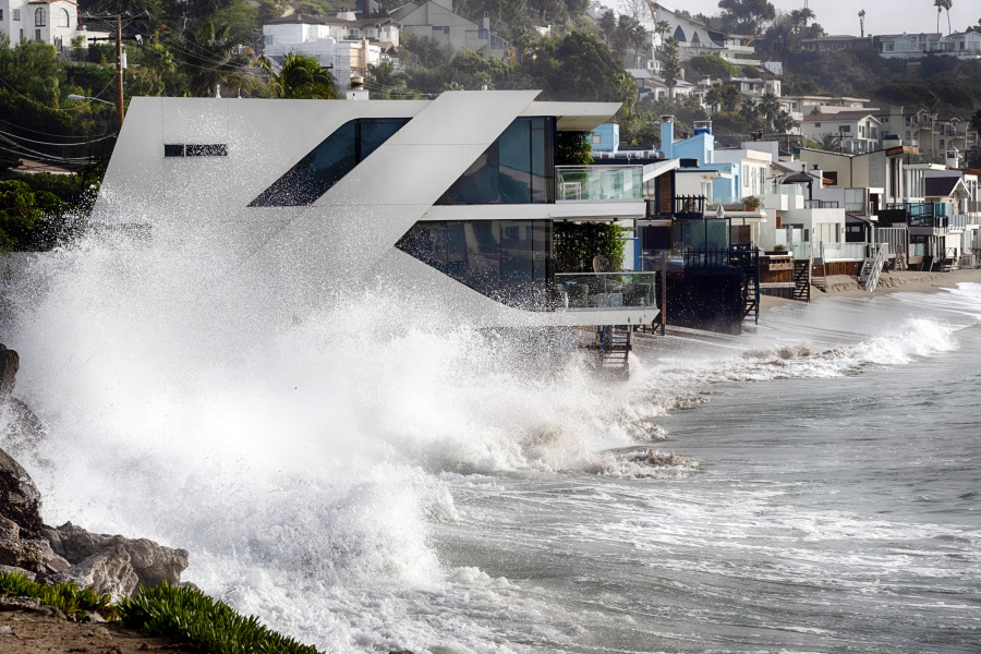 Waves smash against a home along the California coast in Malibu Beach, Calif. on Friday, Dec. 29, 2023. Powerful surf rolled onto beaches on the West Coast and Hawaii as a big swell generated by the stormy Pacific Ocean pushed toward shorelines, causing localized flooding.