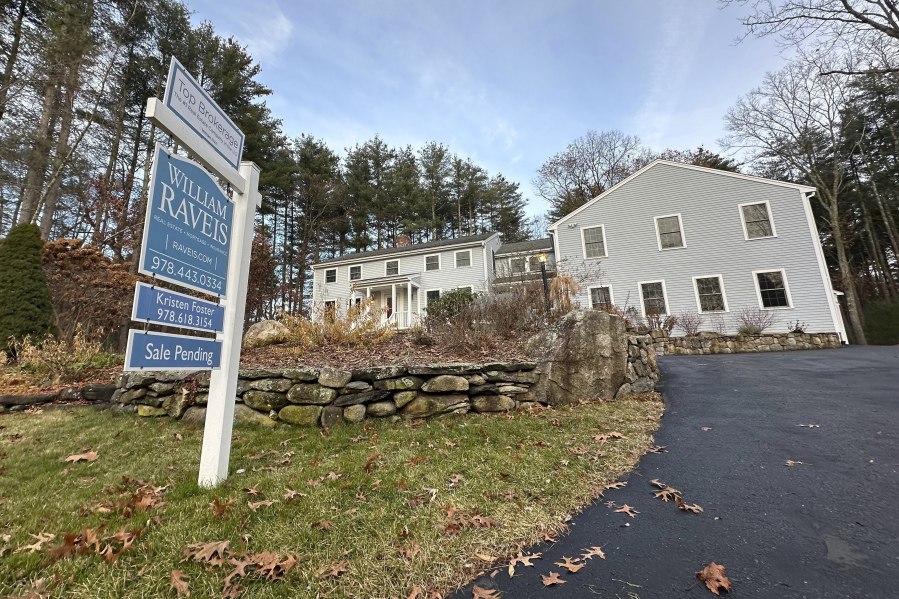 A sale pending sign is displayed in front of a home in Sudbury, Mass. on Saturday, Dec. 2, 2023. On Wednesday, the National Association of Realtors reports on existing home sales for November.