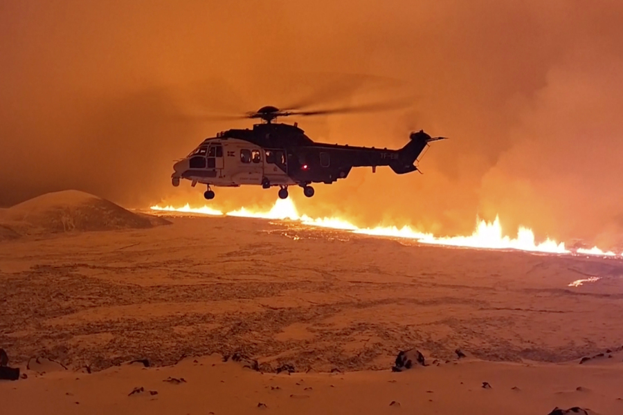 This image made from video provided by the Icelandic Coast Guard shows its helicopter flying near magma running on a hill near Grindavik on Iceland&rsquo;s Reykjanes Peninsula sometime around late Monday, Dec. 18, or early Tuesday, Dec. 19, 2023. A volcanic eruption started Monday night on Iceland&rsquo;s Reykjanes Peninsula, turning the sky orange and prompting the country&rsquo;s civil defense to be on high alert.