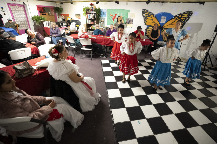 Girls wearing traditional dresses from the Mexico state of Nuevo Leon, perform during a Posada celebration, Sunday, Dec. 17, 2023, in Fort Morgan, Colo. Organizers put on the Posada, a Latin-American tradition based on the religious events of Joseph and Mary searching for shelter before the birth of Jesus, as a way for migrants in Colorado to feel a sense of unity during the holiday season.