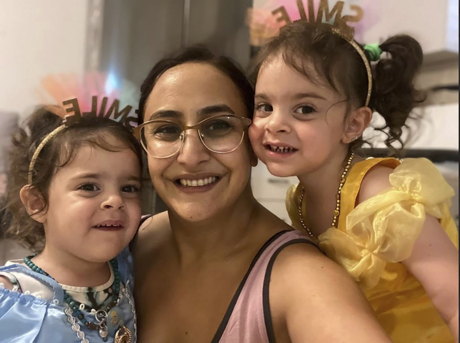 This undated photo provided by Hostages and Missing Families Forum Headquarters shows Sharon Aloni Cunio, center, and her twin daughters, Emma and Yuli, 3 years-old, released Monday, Nov. 27, 2023, to Israel after 52 days in Hamas captivity. Cunio, 34, is the personal advisor for the Head of Ashkol Regional Council. Her husband, David, and his brother Ariel remain in Hamas captivity.