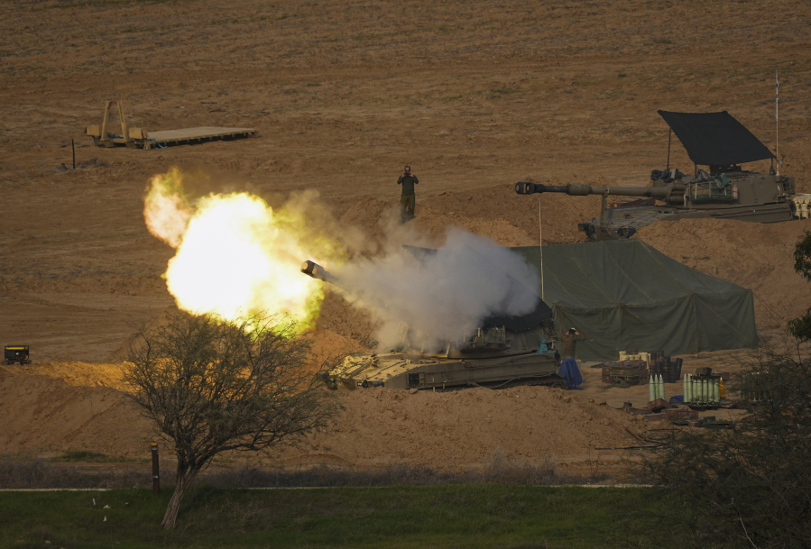 An Israeli mobile artillery unit fires a shell from southern Israel towards the Gaza Strip, in a position near the Israel-Gaza border on Wednesday, Dec. 17, 2023.