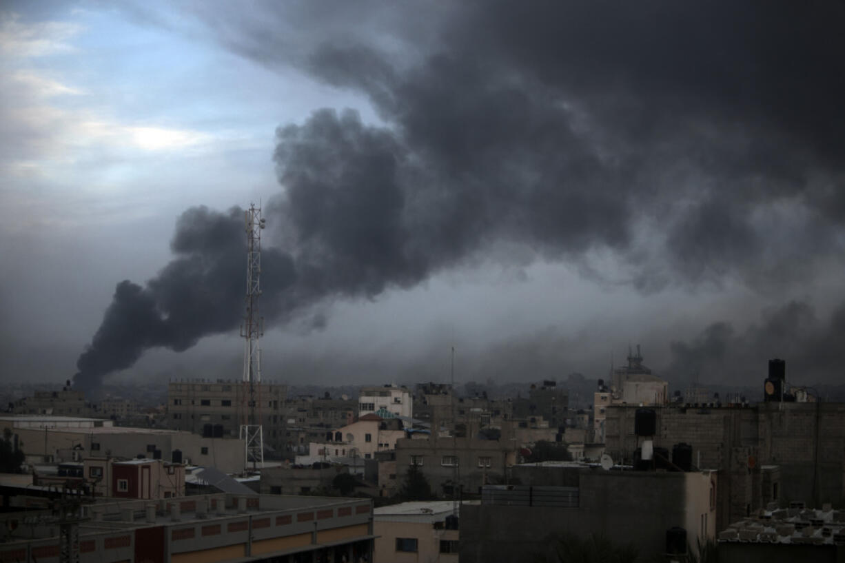 Smoke rises from town of Khan Younis after Israeli strikes on Sunday, Dec. 10, 2023.