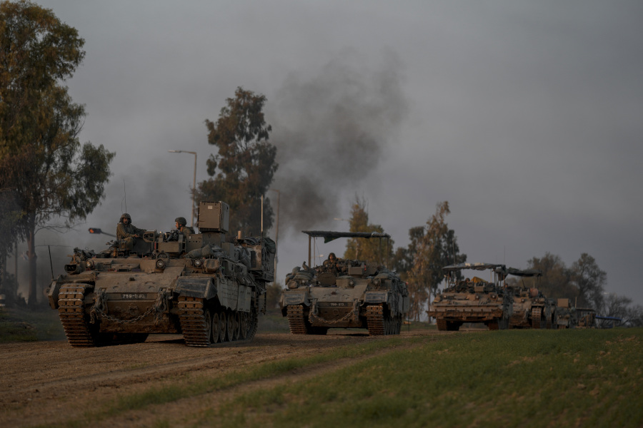 A convoy of Israeli army armoured personnel carriers (APC) moves near the Israeli-Gaza border, in southern Israel, Monday, Dec. 25, 2023. The army is battling Palestinian militants across Gaza in the war ignited by Hamas&rsquo; Oct. 7 attack into Israel.