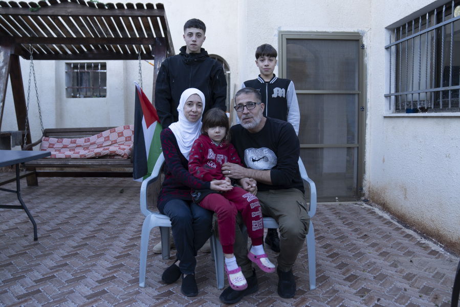 The Palestinian Tamimi family pose for a photo with their son Wisam, 17 rear left, a released prisoner under the Israel Hamas cease fire agreement last week, at the family house in the West Bank village of Nabi Saleh, northwest of Ramallah, Thursday, Nov. 30, 2023. The release of Palestinian prisoners under the Israel-Hamas cease-fire agreement last week has touched nearly everyone in the occupied West Bank, where 750,000 Palestinians have been arrested since 1967. In negotiations with Israel to free hostages in Hamas captivity in Gaza, the militant group has pushed for the release of high-profile prisoners. But experts say most Palestinians passing through Israel&rsquo;s ever-revolving prison door are young men arrested in the middle of the night for throwing stones and firebombs in villages near Israeli settlements.