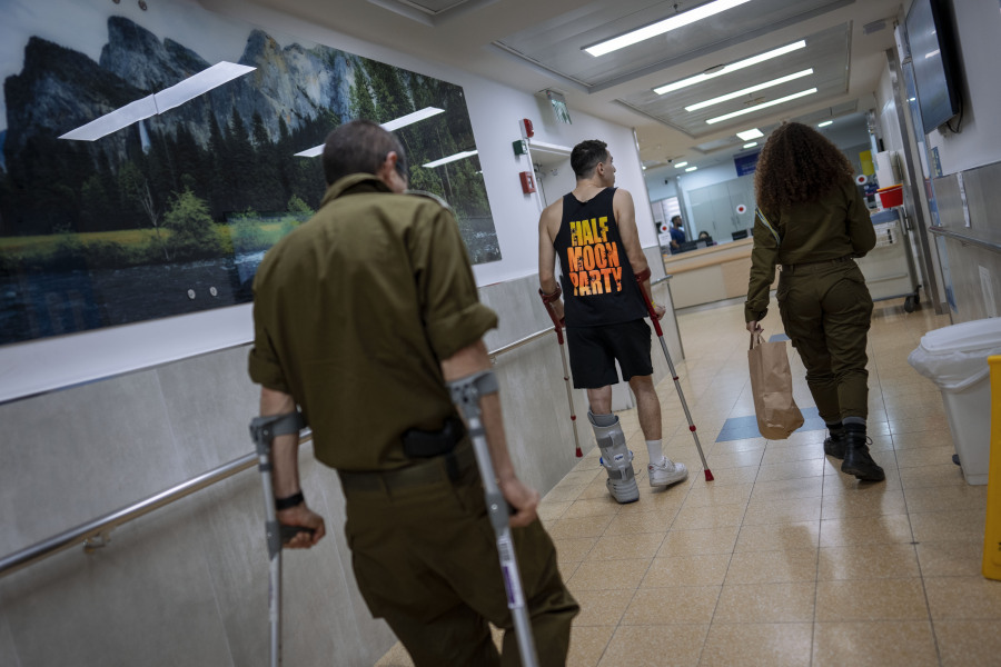 Israeli soldiers wounded in the war with Hamas walk in the rehabilitation division of Sheba hospital in Ramat Gan, Israel, Monday, Dec. 18, 2023.