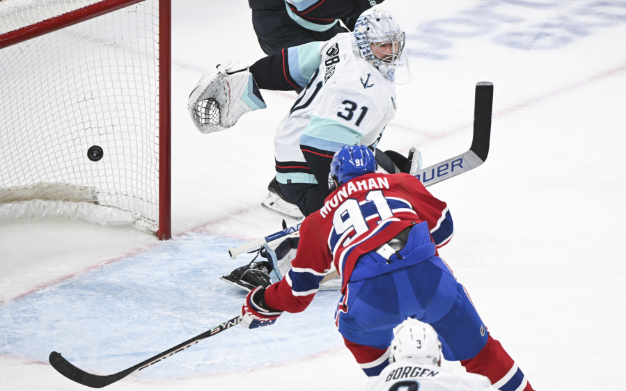 Montreal Canadiens&#039; Sean Monahan (91) scores against Seattle Kraken goaltender Philipp Grubauer (31) during first-period NHL hockey game action in Montreal, Monday, Dec. 4, 2023.