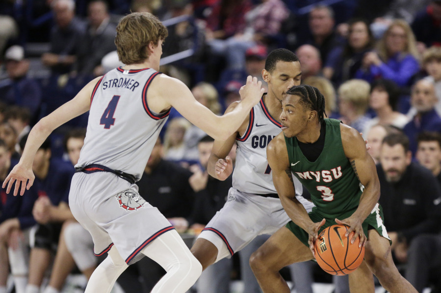 Gonzaga guards Dusty Stromer (4) and Nolan Hickman, center, double-team Mississippi Valley State guard Donovan Sanders (3) during the first half of an NCAA college basketball game, Monday, Dec. 11, 2023, in Spokane, Wash.