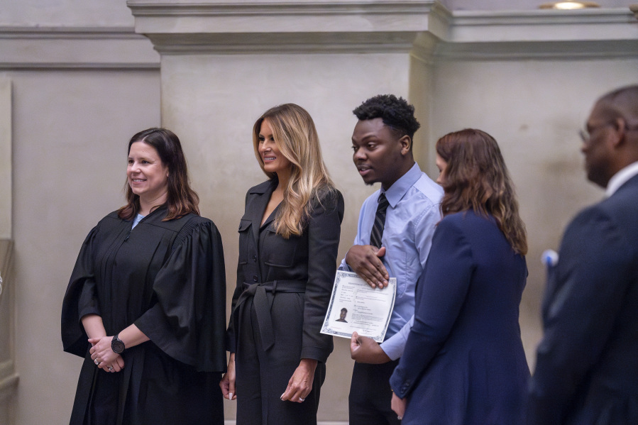 From left, Judge Elizabeth Gunn, and former first lady Melania Trump welcome newly-sworn American citizens as the National Archives holds a naturalization ceremony with 25 people from 25 nations, in Washington, Friday, Dec. 15, 2023. A naturalized citizen herself, Melania Trump, wife of former President Donald Trump, was originally from Slovenia. The event is part of the Archives&rsquo; annual celebration of Bill of Rights Day. (AP Photo/J.