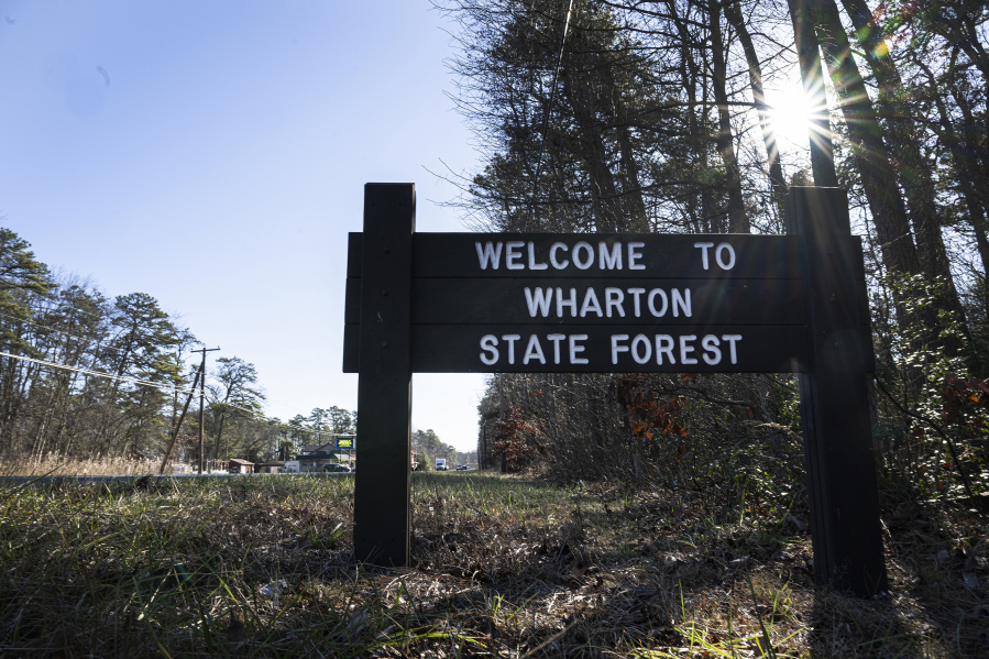 A Wharton State Forest sign stands along side of the road in Washington Township, N.J., Wednesday, Dec. 20, 2023. Investigators are examining the wreckage of a TV news helicopter that crashed in the New Jersey Pinelands, killing the pilot and a photographer on board. WPVI-TV of Philadelphia says a two members of its news team were in the helicopter when it went down Tuesday evening in Wharton State Forest. (Jose F.