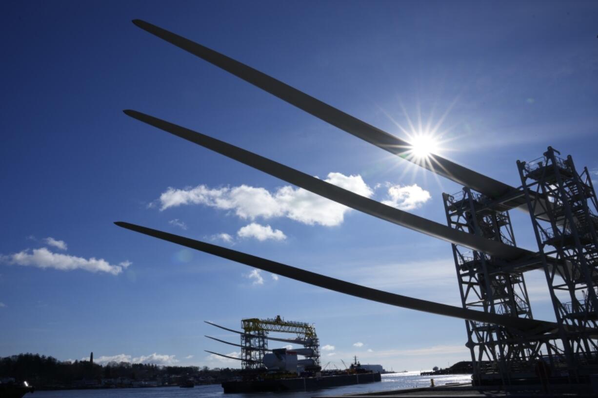 A generator and its blades, bottom, are tugged at sea leaving State Pier in New London, Conn., Monday, Dec. 4, 2023, heading to South Fork Wind farm.