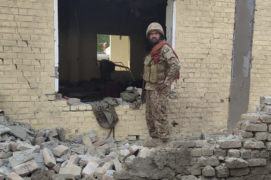 An army soldier examines damages on the site of a bombing at a police station on the outskirts of Dera Ismail Khan, Pakistan, Tuesday, Dec. 12, 2023. A suicide bomber detonated his explosive-laden vehicle at a police station&rsquo;s main gate in northwest Pakistan on Tuesday, killing several policemen and wounding more than dozen others, officials said. Some militants also opened fire and a shootout between them and security forces was still ongoing, police officer Kamal Khan said.