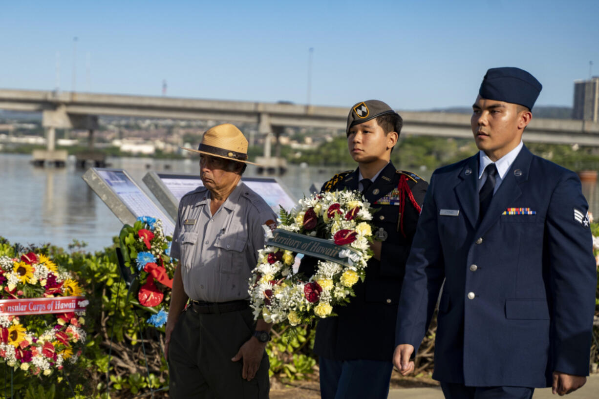 Servicemen and a Park Service ranger present a wreath during the 82nd Pearl Harbor Remembrance Day ceremony on Thursday, Dec. 7, 2023, at Pearl Harbor in Honolulu, Hawaii.