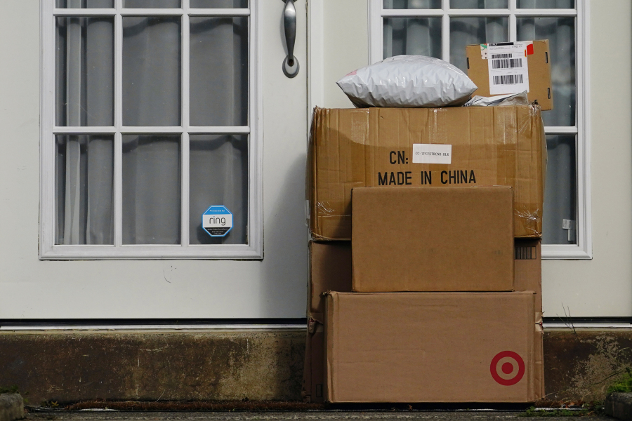 File - Packages are stacked on the doorstep of a home on Oct. 27, 2021, in Upper Darby, Pa. Retailers and delivery companies have been trying to combat the theft of delivered packages in a variety of ways.