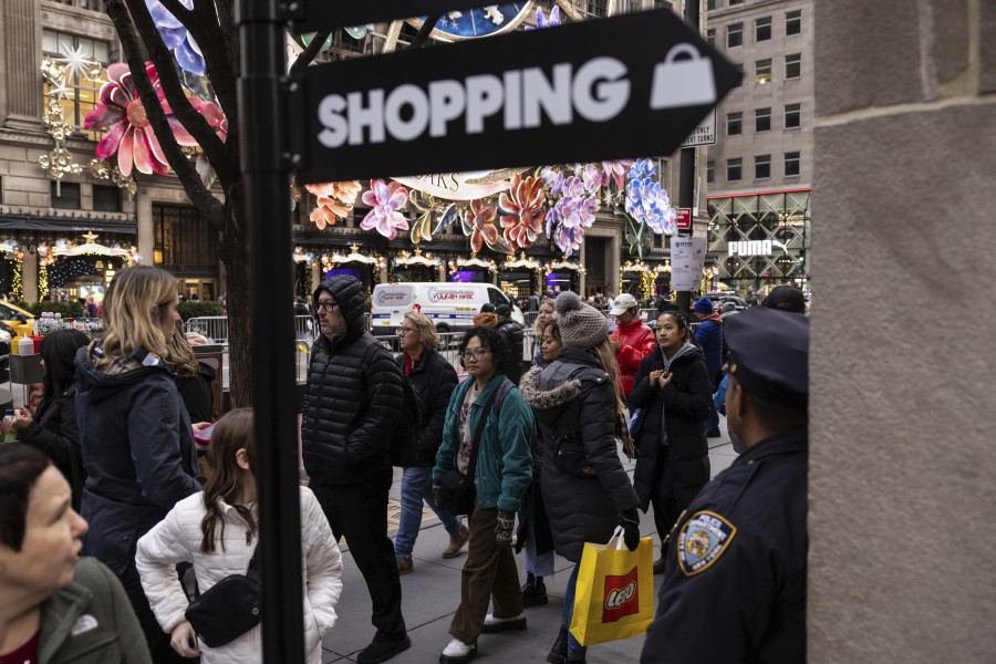 Shoppers and sightseers walk on the 5th Avenue, Monday, Dec. 11, 2023, in New York. On Thursday, the Commerce Department releases U.S. retail sales data for November.