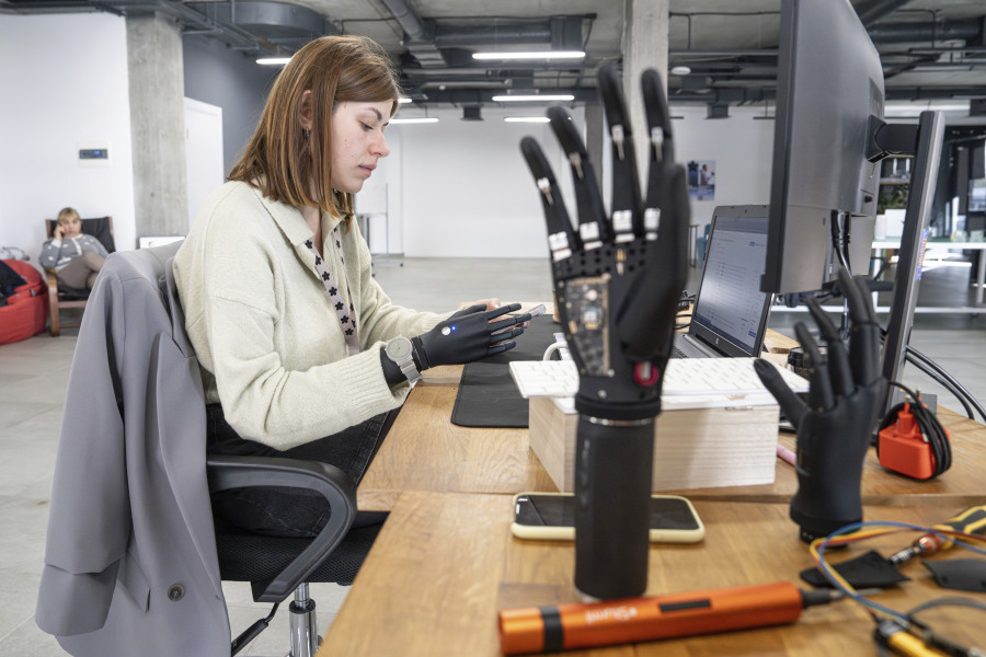 Olena Pozniakova, 28, a quality assurance engineer, tests the app for bionic prostheses at the Esper Bionics office in Kyiv, Ukraine, Tuesday, Oct. 31, 2023. Nearly two years of the brutal war have significantly altered its product distribution, with 70% of the company&rsquo;s manufactured bionic hands now remaining in Ukraine.