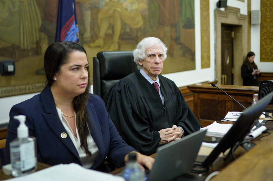 Judge Arthur Engoron, right, sits on the bench with principal law clerk Allison Greenfield, before the start of proceedings in a civil business fraud trial against the Trump Organization at New York Supreme Court, Thursday, Dec. 7, 2023, in New York.