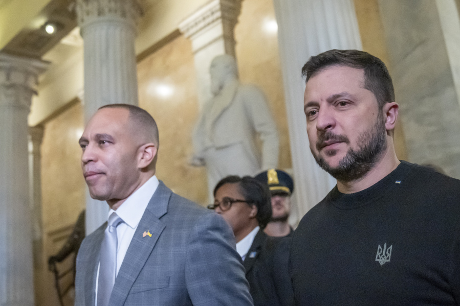 House Minority Leader Hakeem Jeffries of N.Y., left, walks with Ukrainian President Volodymyr Zelenskyy in the U.S. Capitol to a meeting with other congressional leaders, Tuesday, Dec. 12, 2023, in Washington.