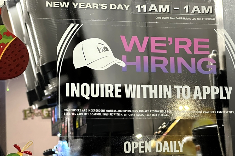 A hiring sign is displayed at a restaurant in Glenview, Ill., Tuesday, Dec.12, 2023. On Thursday, the Labor Department reports on the number of people who applied for unemployment benefits last week. (AP Photo/Nam Y.