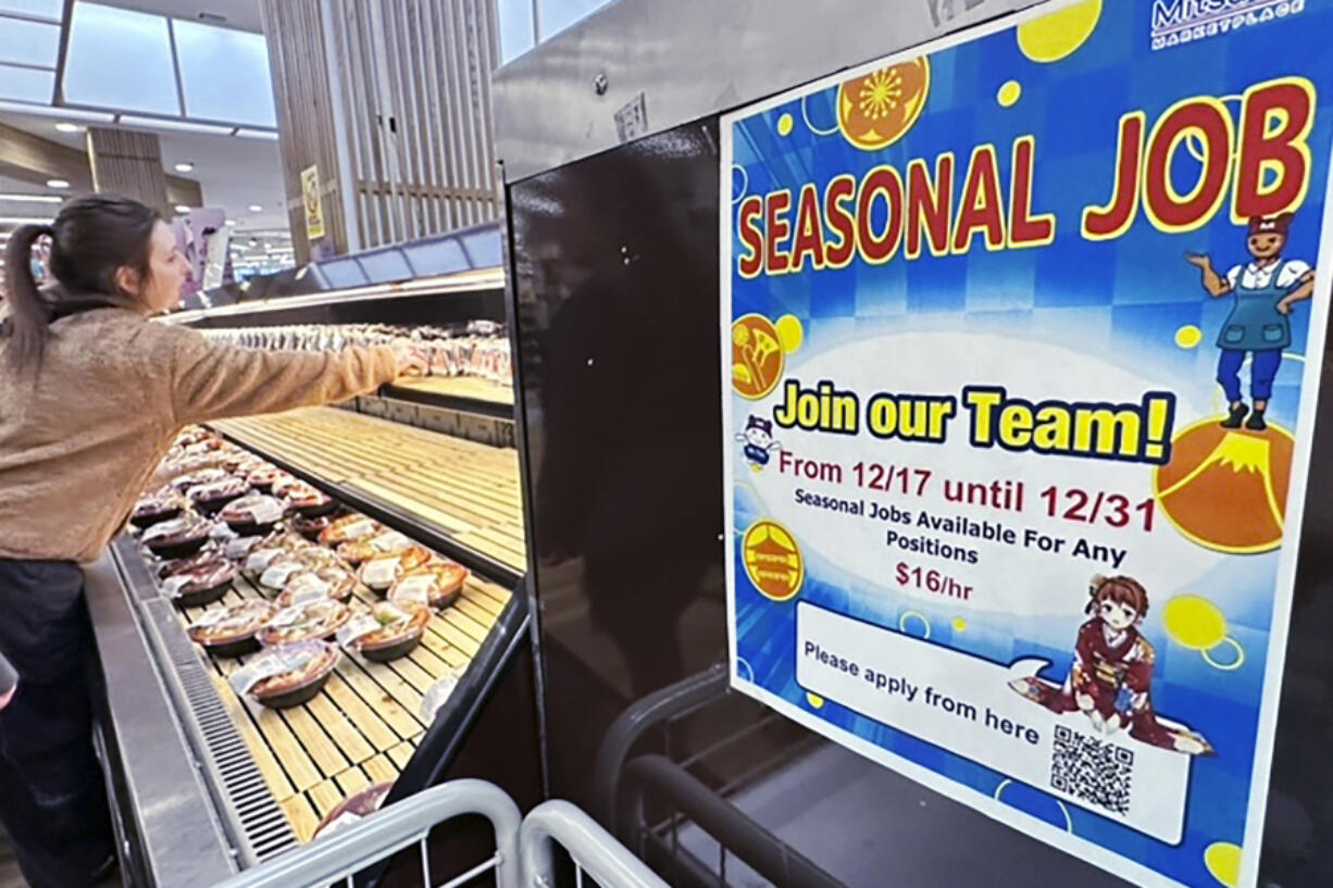 A hiring sign is displayed at a grocery store in Arlington Heights, Ill., Monday, Dec. 4, 2023. On Thursday, the Labor Department reports on the number of people who applied for unemployment benefits last week.(AP Photo/Nam Y.