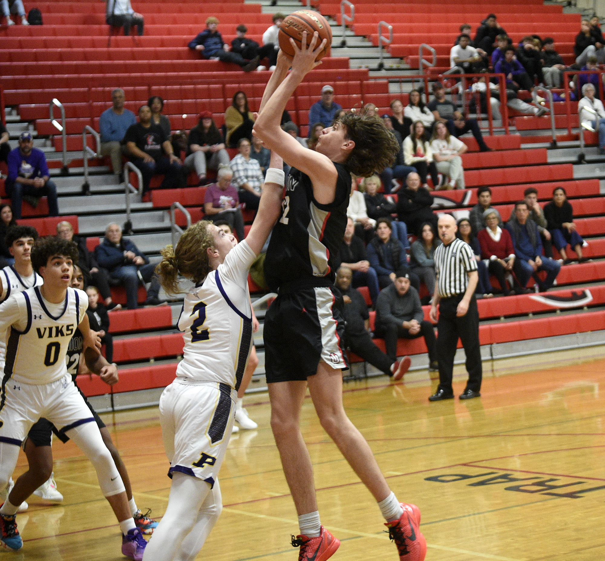 Kody Holcomb of Union takes a shot over Carson Lovett (2) of Puyallup in the Myron Lawrence Memorial Tournament at Fort Vancouver High School on Thursday, Dec. 28, 2023.