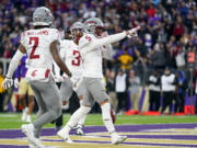Washington State wide receiver Lincoln Victor (5) points after making a touchdown against Washington during the second half of an NCAA college football game Saturday, Nov. 25, 2023, in Seattle.