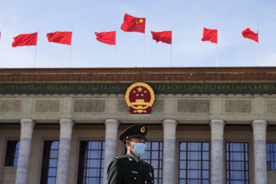 File - A Chinese soldier stands guard outside the Great Hall of the People after the opening ceremony of The Third Belt and Road Forum in Beijing, Oct. 18, 2023. In China, growth is hobbled by the collapse of an overbuilt real estate market, sagging consumer confidence and high rates of youth unemployment.