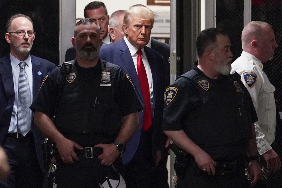 Former President Donald Trump is escorted to a courtroom in New York on April 4, 2023. Trump is accused of falsifying internal business records at his private company while trying to cover up an effort to illegally influence the 2016 election by arranging payments that silenced claims potentially harmful to his candidacy.