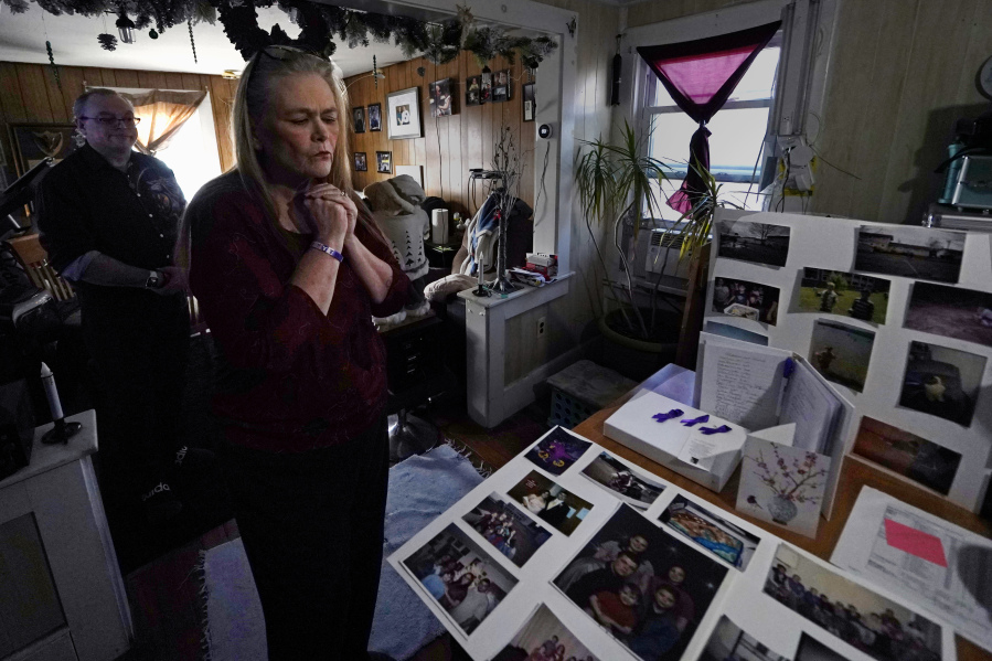 Trina Cotter clutches a pendant containing some of the ashes of her son, Zach Robinson, during an interview at their family home, Thursday, Nov. 30, 2023, in Dover, N.H. Robinson spent decades trying to fight off nightmares about being raped as a child at New Hampshire&rsquo;s youth detention center. He died last in November, still waiting for accountability for his alleged abusers.