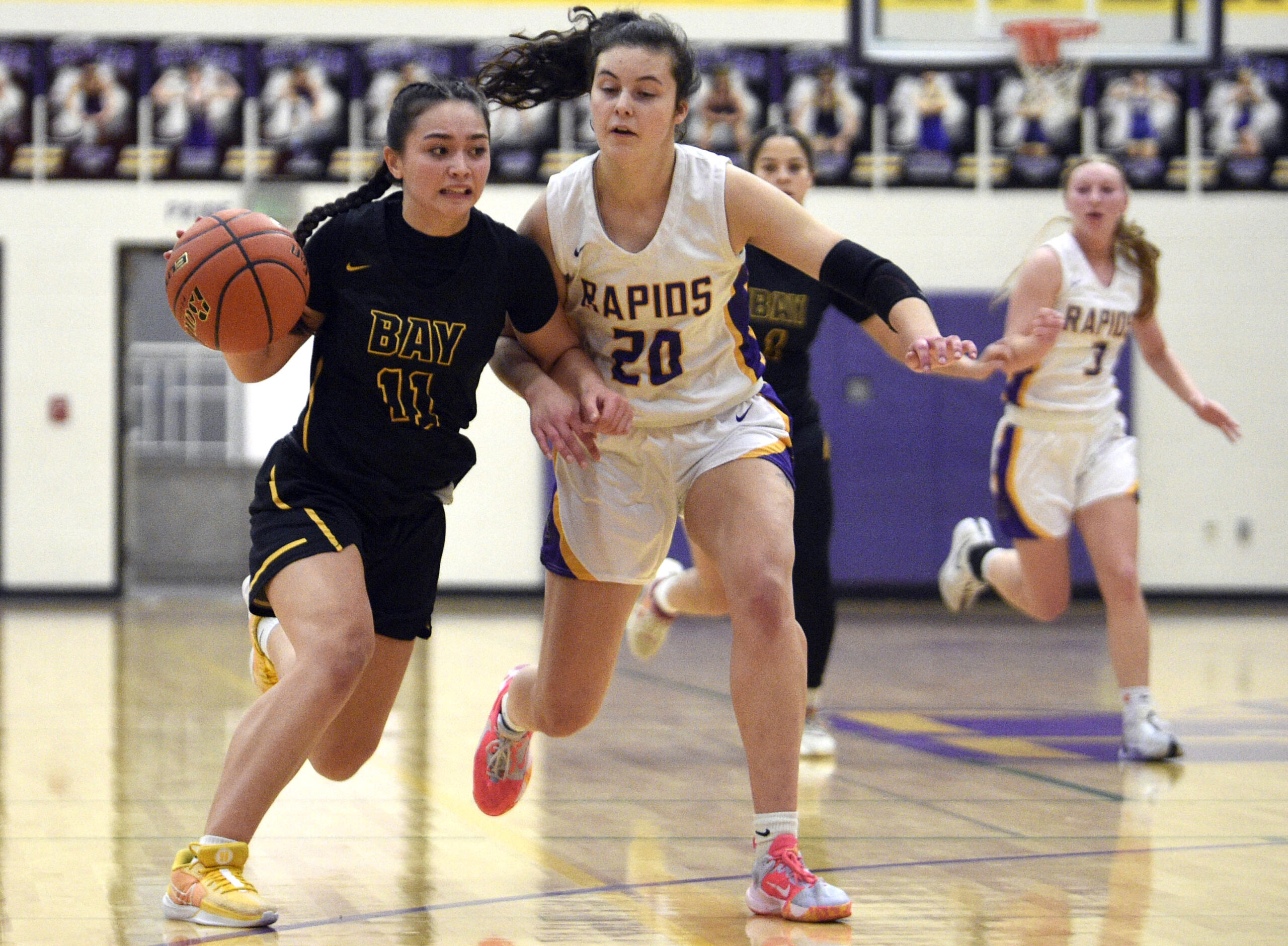 Hudson’s Bay’s Olivia Carroll (11) tries to get past Columbia River’s Emma Iniguez (20) on a drive during a 2A GSHL girls basketball game on Wednesday, Jan. 3, 2024, at Columbia River High School.
