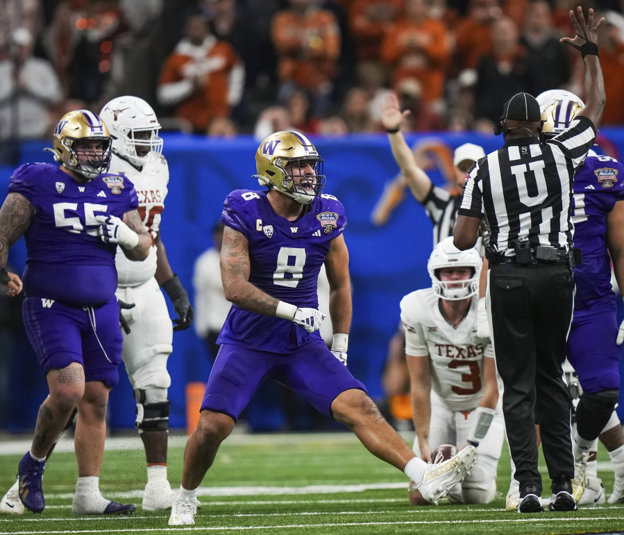 Washington defensive end Bralen Trice (8) celebrates during the second half of the Sugar Bowl CFP NCAA semifinal college football game against Texas, Monday, Jan. 1, 2024, in New Orleans.