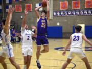 Columbia River’s Aaron Hoey (23) shoots over Ridgefield’s Colton Warren (2) during a 2A GSHL boys basketball game on Thursday, Jan. 4, 2024, at Ridgefield High School.