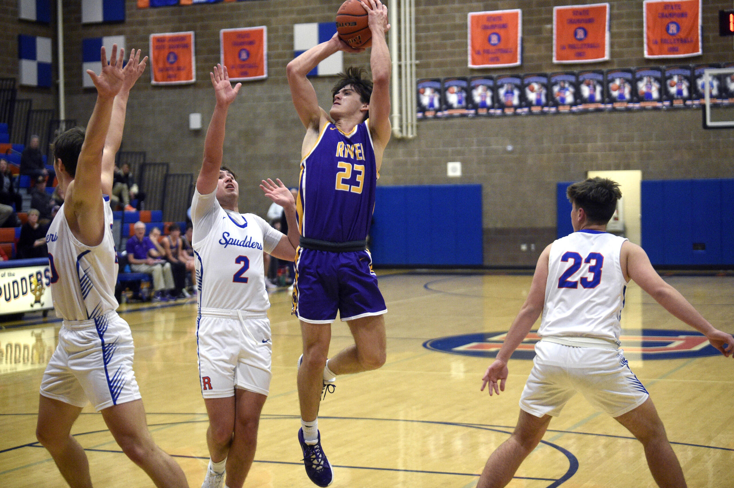 Columbia River’s Aaron Hoey (23) shoots over Ridgefield’s Colton Warren (2) during a 2A GSHL boys basketball game on Thursday, Jan. 4, 2024, at Ridgefield High School.