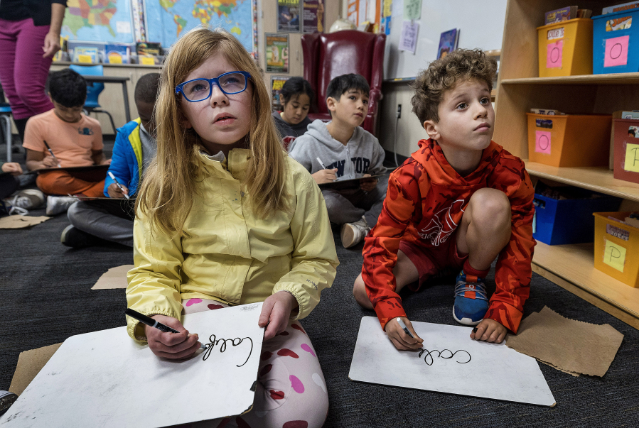 Third-graders learn cursive at Laurel School Upper Campus in Menlo Park, Calif., on Dec. 20. A law taking effect in 2024 will require cursive instruction.
