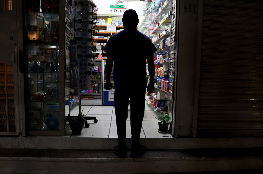 People walk by a pharmacy in the Zona Romantica district of Puerto Vallarta, Mexico, Dec. 5, 2023.