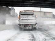 A snow plow clears a highway exit after a winter storm on Feb. 23 in St. Paul, Minn.