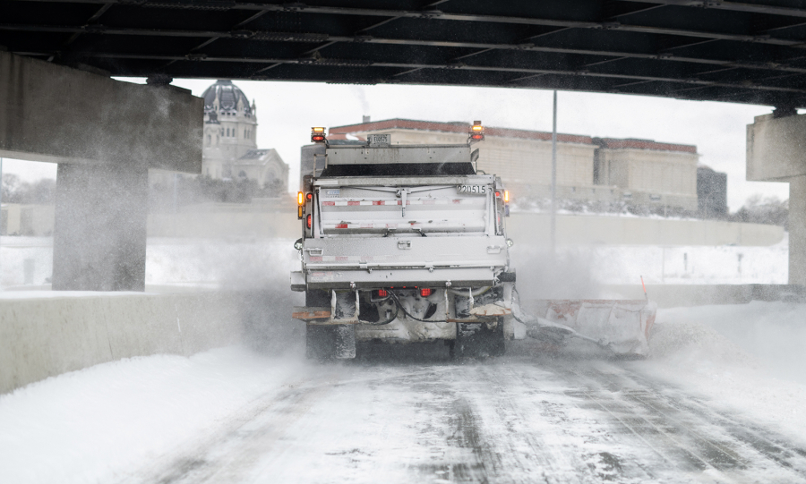 A snow plow clears a highway exit after a winter storm on Feb. 23 in St. Paul, Minn.