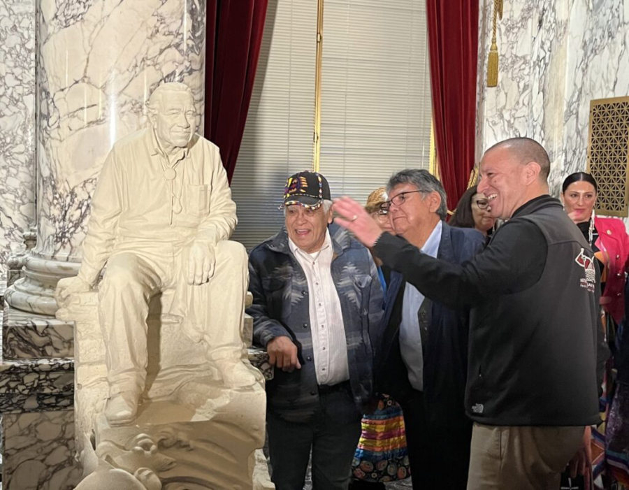 Nisqually Tribal Chairman Willie Frank III, right, discusses the newly designed statue mockup of his father, Billy Frank Jr., with other attendees at Wednesday’s unveiling. A full-scale, bronze statue of Billy Frank Jr. will be placed in the U.S. Capitol’s National Statuary Hall in Washington, D.C. next year.