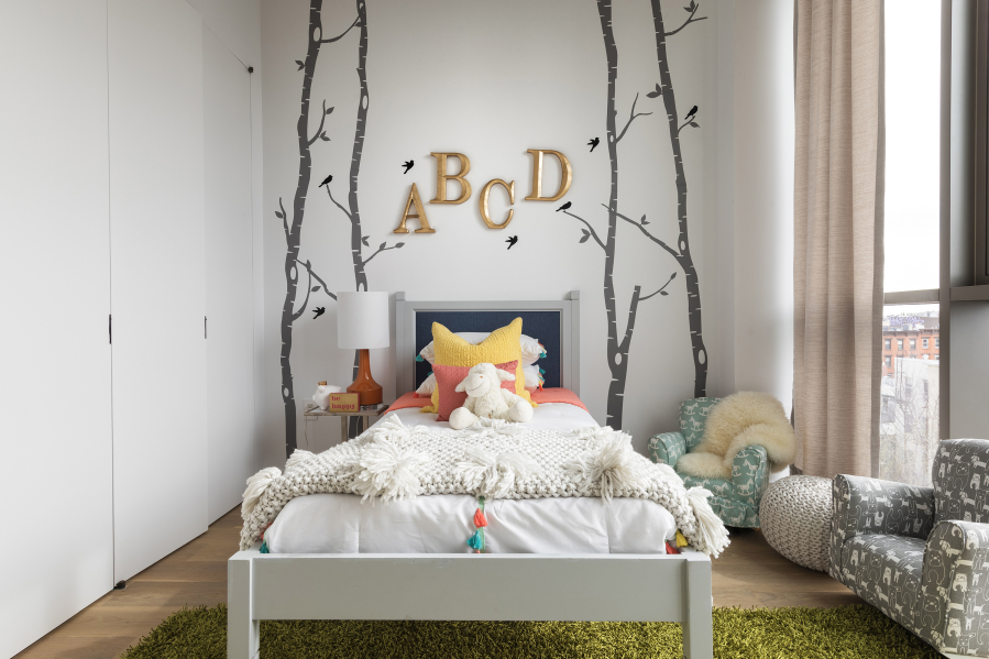 Wall decor such as letters and wall stickers help to add an element of whimsy in this children&rsquo;s bedroom.