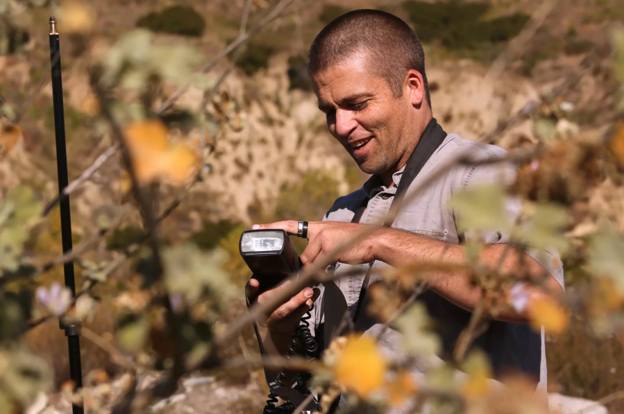 Amateur botanist Matt Smith sets up a flash to photograph a Davidson&rsquo;s bushmallow plant in the Big Tujunga Canyon in Sunland, Calif.