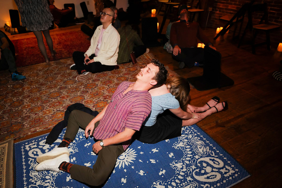 Participants pair up and fall back on each other during The Feels event on a recent December evening.