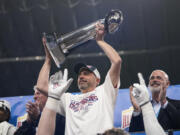 Arizona head coach Jedd Fisch lifts the team's trophy after defeating Oklahoma in the Alamo Bowl NCAA college football game in San Antonio, Thursday, Dec. 28, 2023.