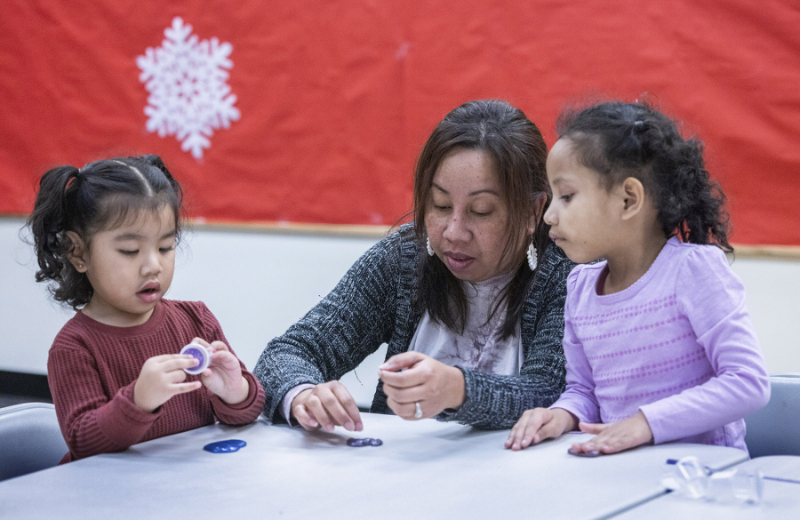 Dianna Johnson (center) plays with Mary Bilimon, 2 (left) and Jera Maun, 5, during their play group class at Childhaven in Auburn Tuesday, Jan. 9, 2024. (Ellen M. Banner/The Seattle Times/TNS) (Ellen M.